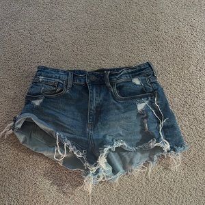 dark denim jean distressed shorts